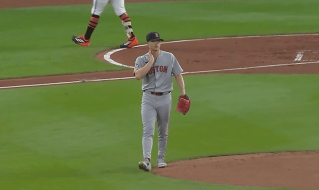 Sonny Gray walking around the mound with his fingers on his neck.